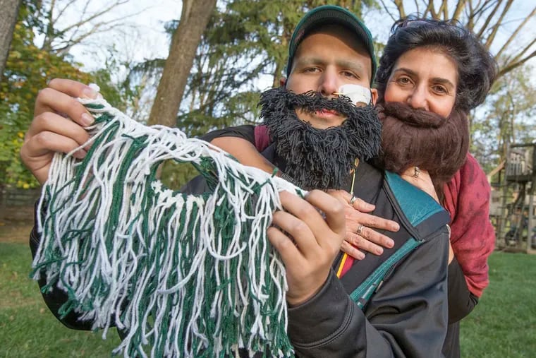 Ben Levit, diagnosed with Burkitt's lymphoma, and mom Ana with beards people have sent them (one in Eagles' colors) for Levit's Beard Cancer Challenge.