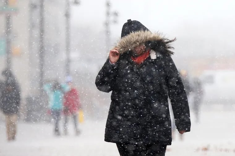 A pedestrian is caught in a snow squall on the campus of Drexel University in Philadelphia on Wednesday, Jan. 30, 2019. The National Weather Service is forecasting temperatures to drop into the single digits overnight. (Tim Tai/Philadelphia Inquirer/TNS)