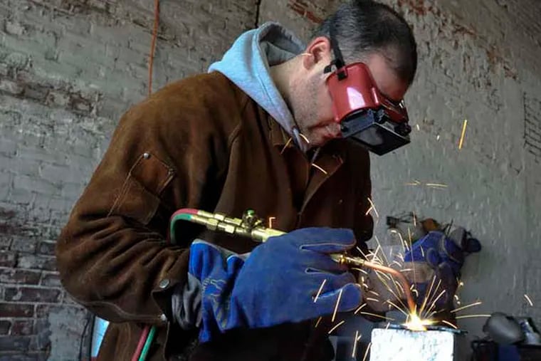 Gustavo Actis uses the welding equipment at the Philadelphia Sculpture Gym, an artist's collaborative where sculptors have access to heavy-duty industrial tools need to make their art. Janurary 1, 2013 ( RON TARVER / Staff Photographer )
