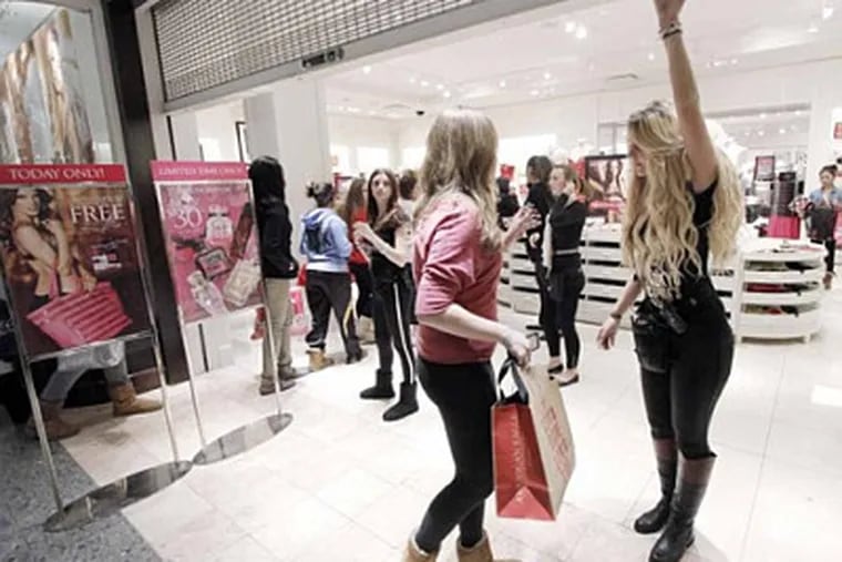 The line went down the mall for Victorias Secret in the Deptford Mall. Store associates (far right) had to monitor the exit to be sure people were not sneaking in on November 23, 2012. ( ELIZABETH ROBERTSON / Staff Photographer )