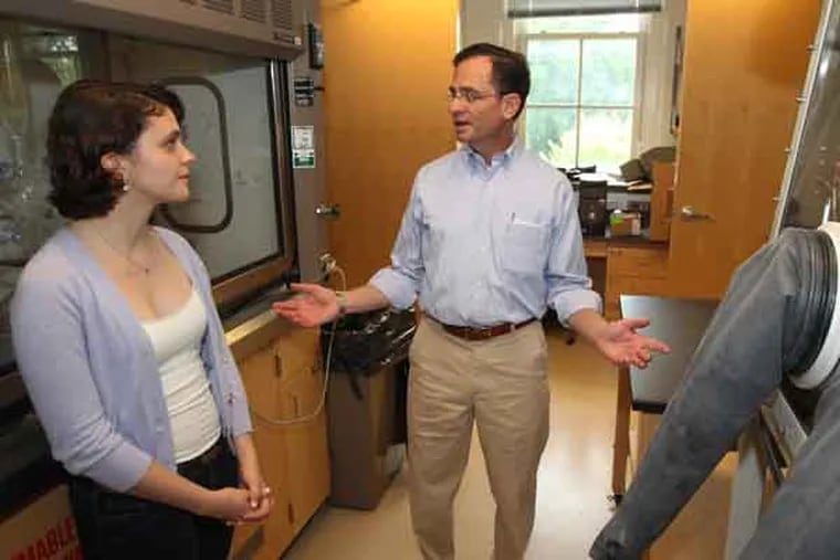 New Haverford President Daniel Weiss, center, talks to junior chemistry major, Emily McKinstry, left, about her research as he takes a tour of the Koshland Integrated Science Center at Haverford College. He started on July 1. In a three-year period, half of the four-year college presidents in the Philadelphia region have turned over or will turn over.  07/10/2013 ( MICHAEL BRYANT / Staff Photographer )