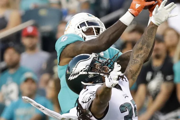 Dolphins wide receiver DeVante Parker catches the football over Eagles cornerback Ronald Darby during the first quarter Thursday night.