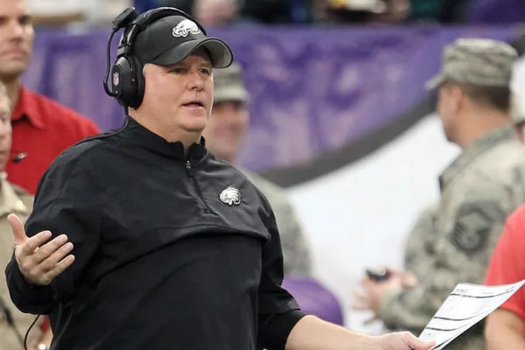 Chip Kelly raises his arms after a penalty on his team in the first quarter against the Minnesota Vikings. (Yong Kim/Staff Photographer)