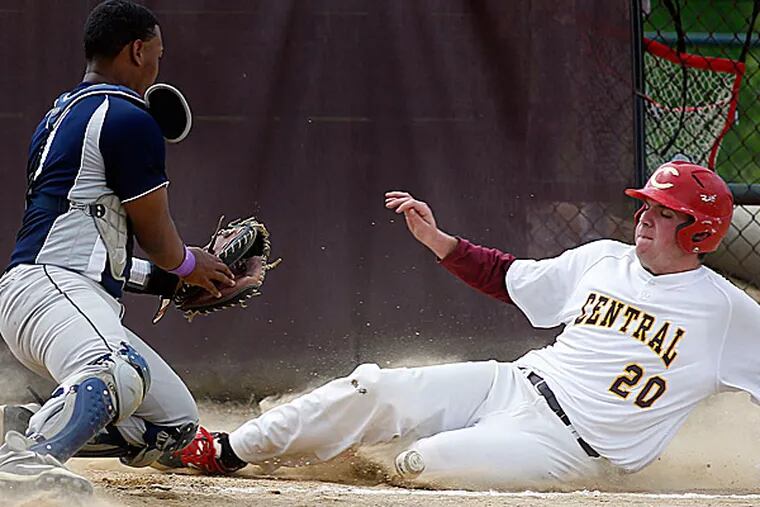 Central's Anthony DeVito slides into home plate as Olney catcher Ray
Cedano loses the baseball. (Yong Kim/Staff Photographer)