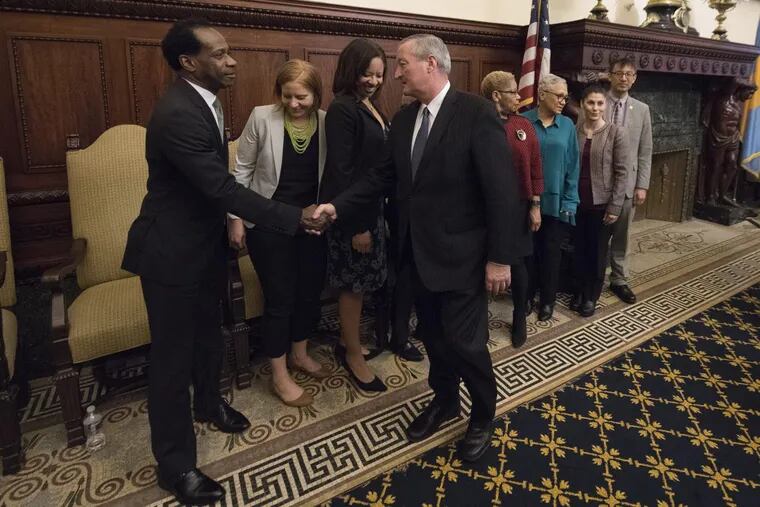 Mayor Kenney shakes hands with newly introduced school board member Wayne Walker, standing with fellow board members (from left) Mallory Fix Lopez, Angela McIver, Julia Danzy (not seen), Joyce Wilkerson, Leticia Egea-Hinton, Maria McColgan, and Lee Huang.