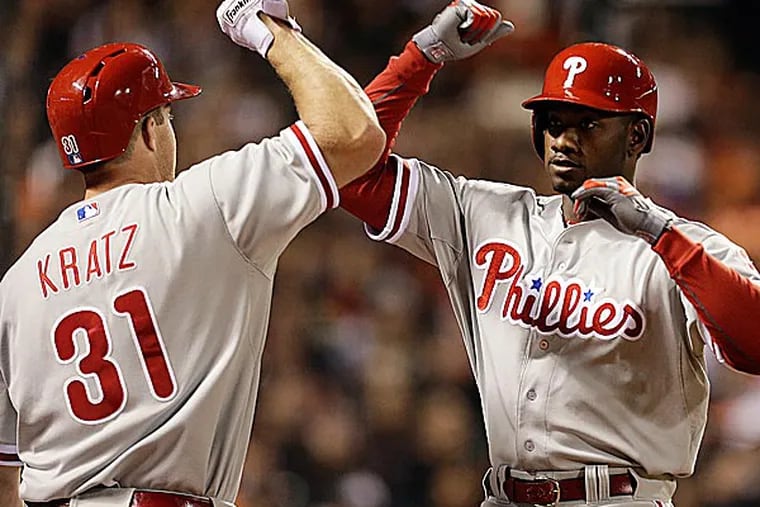 The Phillies' Domonic Brown is congratulated by Erik Kratz after hitting a home run off the Giants' Madison Bumgarner in the fifth inning. (Ben Margot/AP)