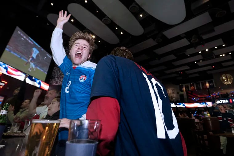 Team USA soccer fans Billy Powers (left) and Chris Karpovich celebrate as they watch their team's World Cup match against Iran at Xfinity Live.
