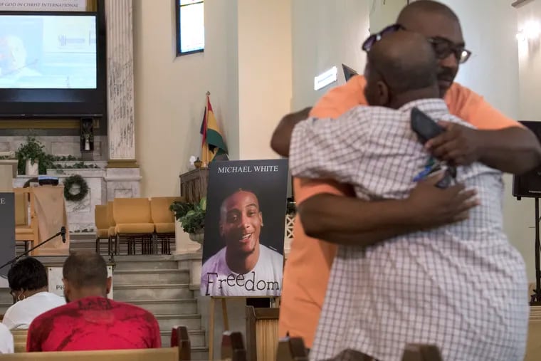 A photo of Michael White is shown as Relatives and friends gathered before a vigil at the True Gospel Tabernacle Church in South Philadelphia. Tuesday, July 31, 2018. White is accused of fatally stabbing city developer Sean Schellenger near Rittenhouse Square earlier this month.