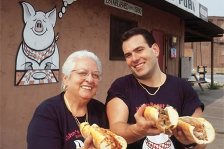 Top of the heap: John Bucci Jr. and his mother, Vonda, serve up
succulent steaks at John’s Roast Pork in South Philly.