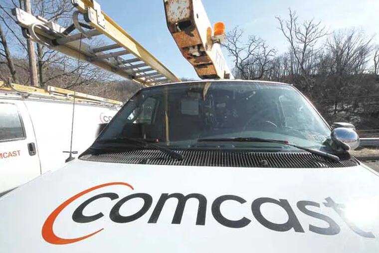 This Feb. 15, 2011 file photo, shows a Comcast logo on a Comcast installation truck in Pittsburgh. Comcast said Wednesday, Nov. 2, 2011, its profit rose 5 percent in the third quarter as revenue at the nation's biggest cable television company climbed 51 percent. (AP Photo/Gene J. Puskar, File)