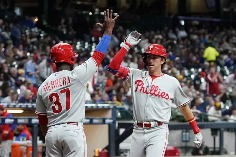 Philadelphia Phillies' Bryson Stott is congratulated bt Odubel Herrera after hitting a two-run home run during the third inning of a baseball game against the Milwaukee Brewers Wednesday, June 8, 2022, in Milwaukee. (AP Photo/Morry Gash)
