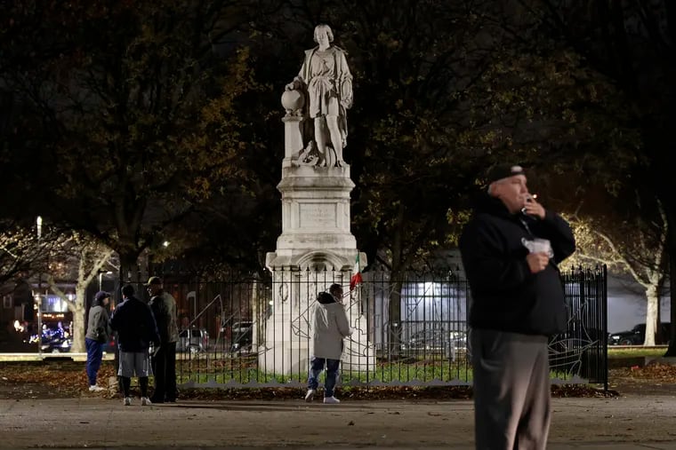 People gather at Marconi Plaza in South Phila. where, as of 10:30 p.m. Sunday, the Christopher Columbus statue was unboxed.