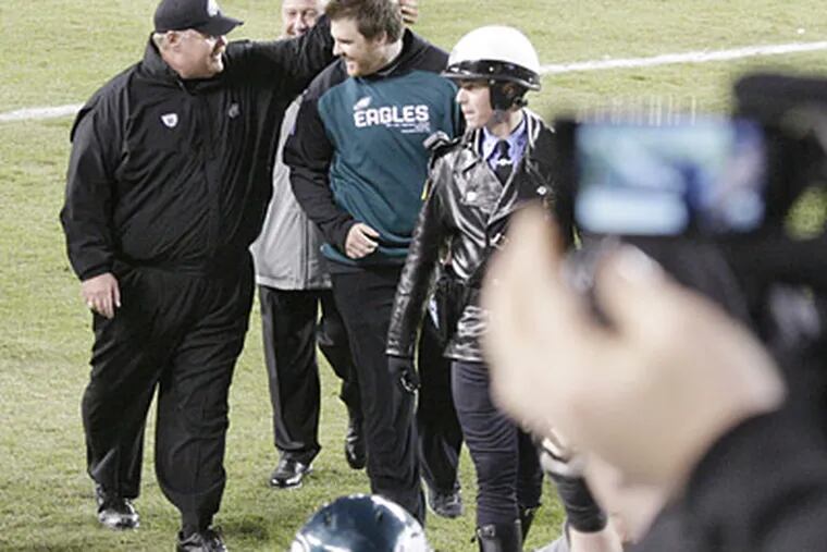 Eagles coach Andy Reid walks with son Garrett after an Eagles win in 2010. (Elizabeth Robertson / Staff File Photo)