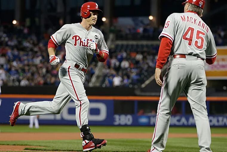 Philadelphia Phillies' Chase Utley passes third base coach Pete Mackanin (45) on the way home after hitting a first-inning solo home run off New York Mets starting pitcher Matt Harvey in a baseball game in New York, Tuesday, April 14, 2015. (Kathy Willens/AP)