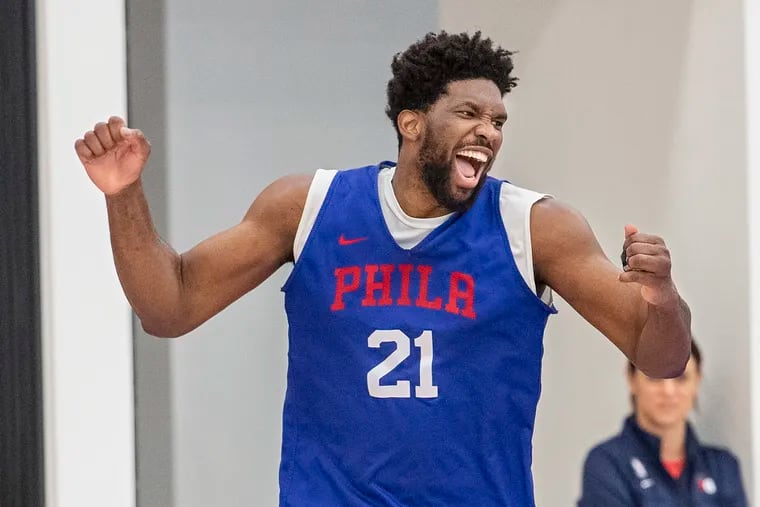 Sixer center Joel Embiid reacts to making a shot during practice at the Sixers practice facility in Camden in February.