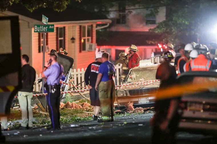 Firefighters, EMS, ATF and police on the scene of a house explosion on Washington Street in Pottstown on Thursday. A car covered in debris next to where the once stood.