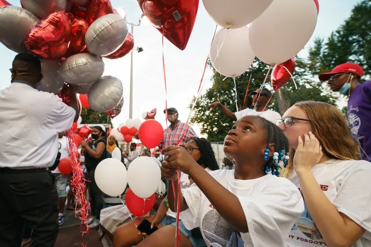 Carlee Lynn, center, at a balloon release for her sister Simone-Monea Rogers, at Jerome Brown Rec Center, in Philadelphia, August 26, 2021.