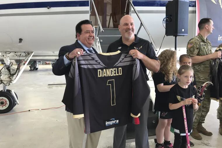 Inspira Health Network CEO John DiAngelo (left) and Wings head coach/general manager Paul Day (right) pose during the unveiling of the Philadelphia Wings home jerseys on Tuesday.