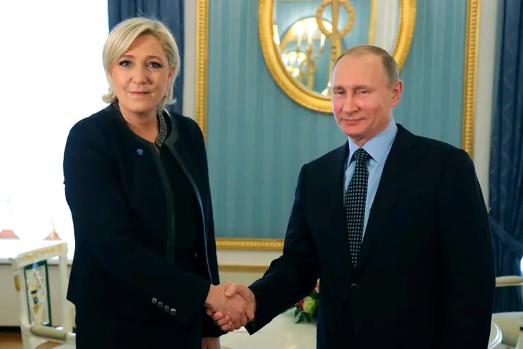 Russian President Vladimir Putin with French far-right presidential candidate Marine Le Pen at the Kremlin in Moscow in 2017. Jailed Russian opposition leader Alexei Navalny threw a bombshell into France's presidential election campaign this month, alleging that Putin may have bought off Le Pen with a bank loan.