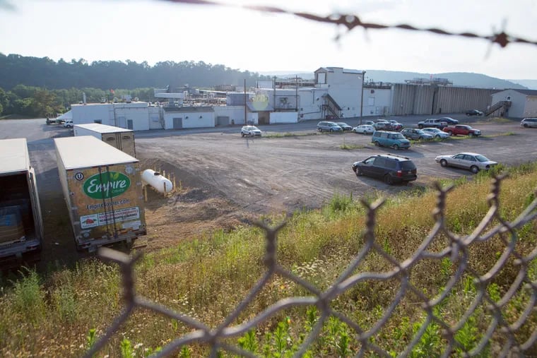 The Empire Kosher poultry processing plant in Miffilintown, Pa. can be seen behind this chain-link fence. Due to strict kosher food processing requirements, rabbis from New York, New Jersey and Maryland commute here, increasing risk of COVID-19 transmission. For the Inquirer/Kalim A. Bhatti