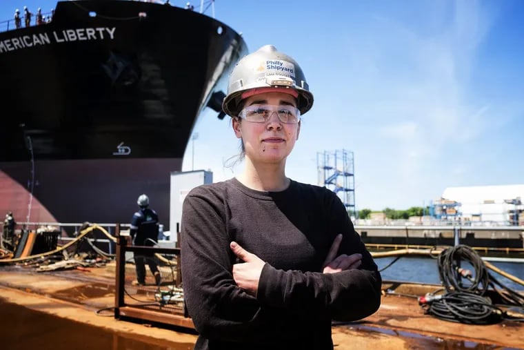 Samantha Toggas, Temple graduate and apprentice welder, at the Philadelphia shipyard in front of the project tanker ship &quot;American Freedom,&quot; the 27th ship built at the yard.