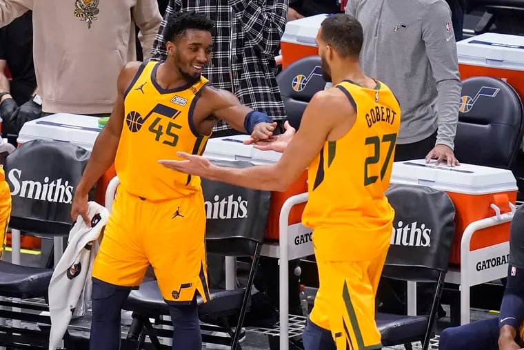 Utah Jazz’s Donovan Mitchell (45) celebrates with teammate Rudy Gobert (27) after leaving the game in the second half against the New Orleans Pelicans Tuesday, Jan. 19, 2021, in Salt Lake City.