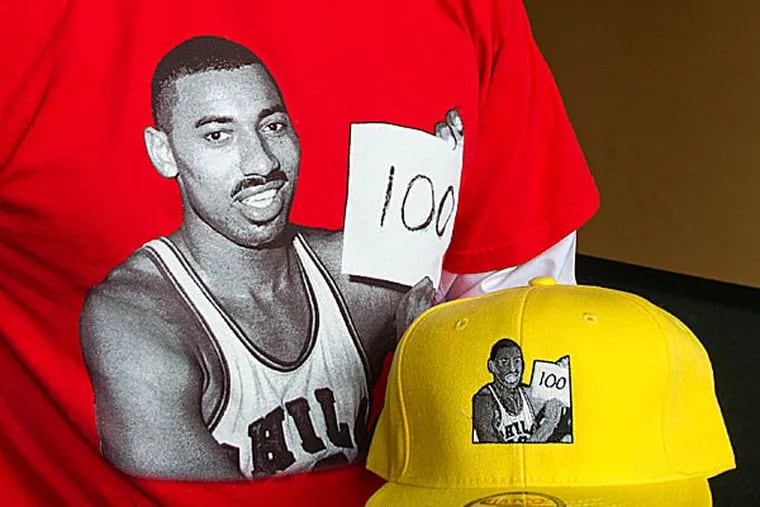 The photograph of Wilt Chamberlain clutching a plain piece of paper on which "100" had been hurriedly scrawled, minutes after he'd reached that unimaginable point total in an NBA game, is at the heart of a 44-year-old Roslyn man's ambition. (David M Warren/Staff Photographer)