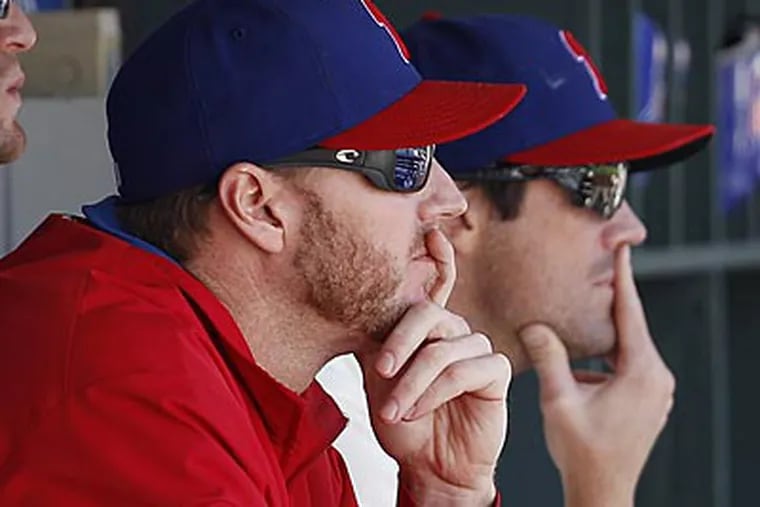 Roy Halladay (left) indicated Saturday he had "spasms" behind his right shoulder. (David Maialetti/Staff Photographer)