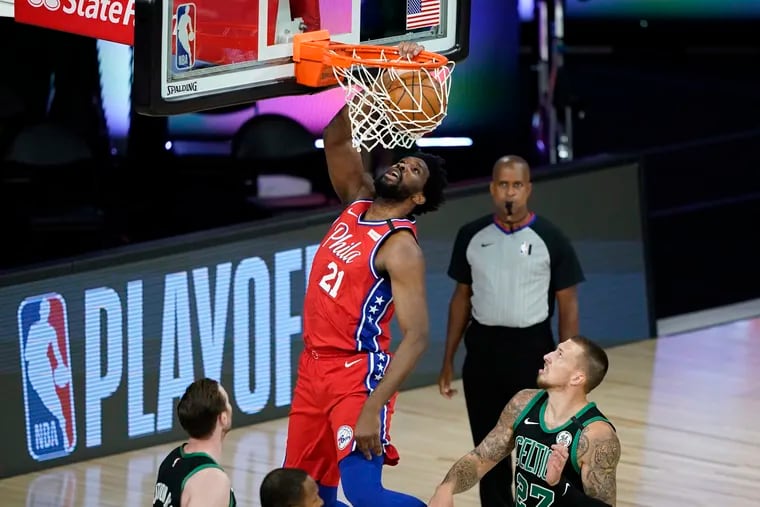 Joel Embiid dunks against the Boston Celtics during the first half.