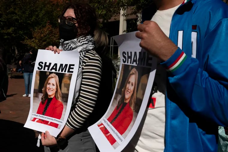 Penn students hold posters of Penn president Liz Magill, criticizing her comments about Palestine, on Monday, Oct. 16, 2023.