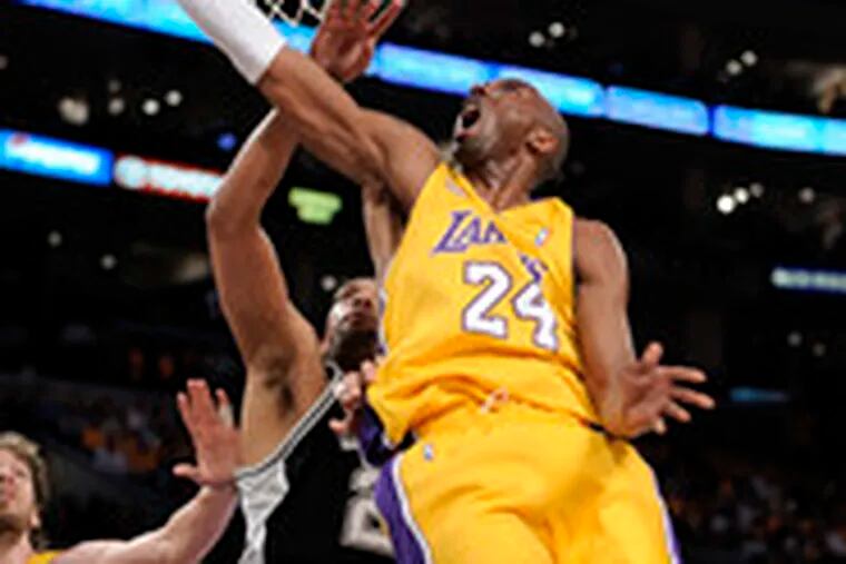 The Lakers&#0039; Kobe Bryant shoots over the Spurs&#0039; Tim Duncan in the the first half of Game 5 of the Western Conference finals. Bryant scored 39 points in the victory.