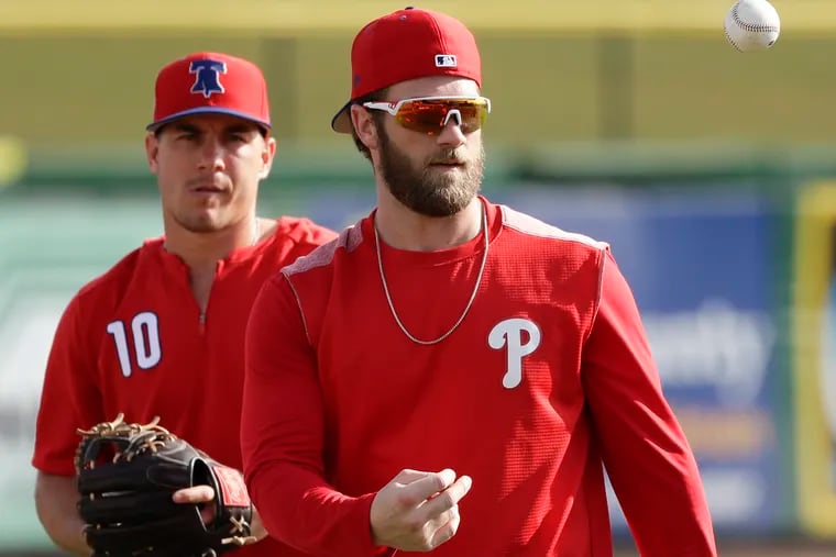 Adding J.T. Realmuto (left) indicated the Phillies moved the goalpost on success. If he and Bryce Harper don't make the playoffs, will 2019 be a failure?