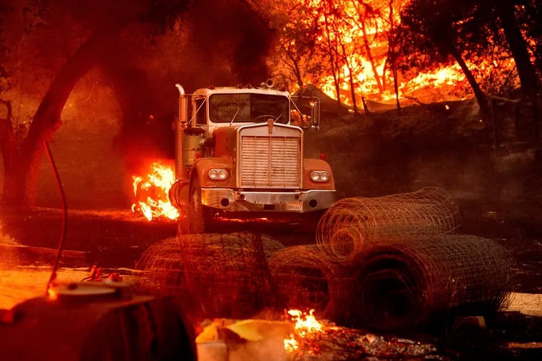 Flames from the Glass Fire burn a truck in a Calistoga, Calif., vineyard Thursday, Oct. 1, 2020.
