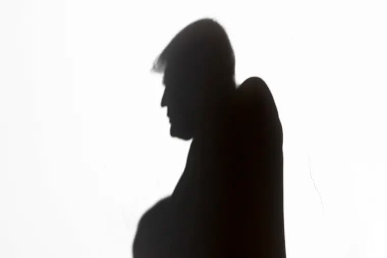 President Donald Trump's silhouette is seen as he walks with Israeli Prime Minister Benjamin Netanyahu before their meeting in the Oval Office of the White House in Washington in January 2020.