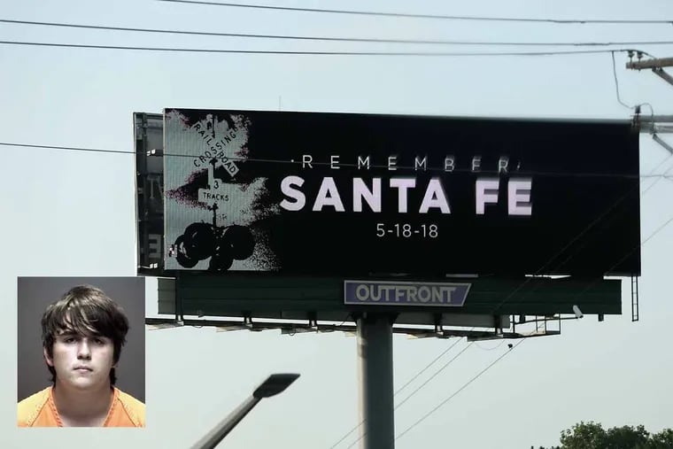 A billboard is seen off of I-45 near Santa Fe, Texas, where a student, Dimitrios Pagourtzis (inset), shot and killed eight classmates and two teachers at Santa Fe High School.