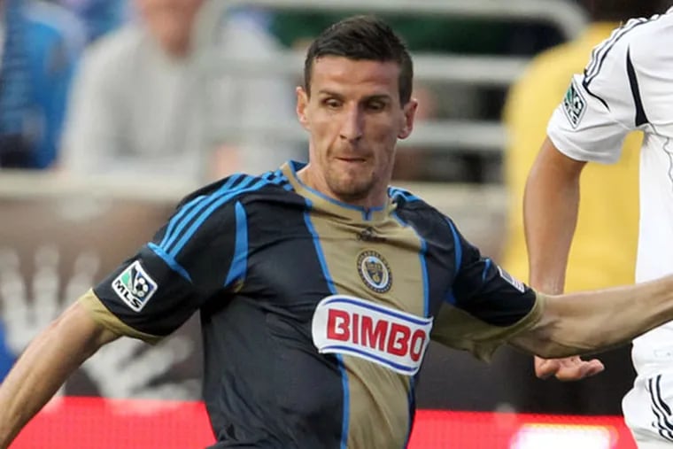 The Union's Sebastien Le Toux (center) moves with the ball against Los
Angeles Galaxy's Tommy Meyer (left) and Omar Gonzalez during the first
half at PPL Park on Wednesday, May 15, 2013. (Yong Kim/Staff Photographer)