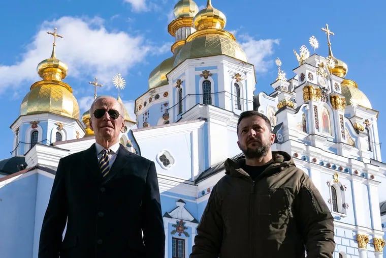 U.S. President Joe Biden, left, walks with Ukrainian President Volodymyr Zelenskyy in front of St. Michael's Golden-Domed Cathedral during an unannounced visit, in Kyiv, on Feb. 20, 2023.