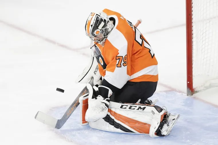 Flyers goalie Carter Hart makes a stop against the New York Islanders in a preseason game Friday. He has a .957 save percentage in the preseason.