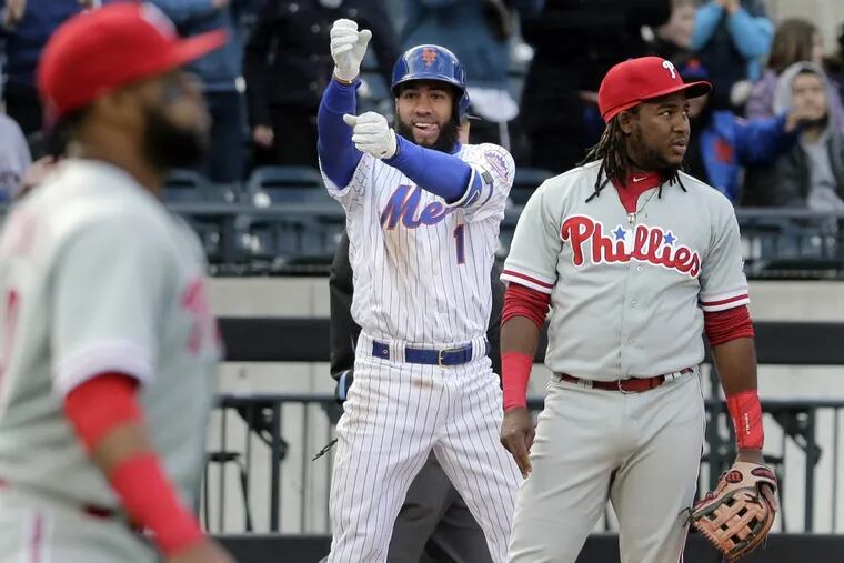 Mets’ infielder Amed Rosario (center) celebrates his two-run triple in the sixth-inning of the Phillies loss to the Mets on April 4.