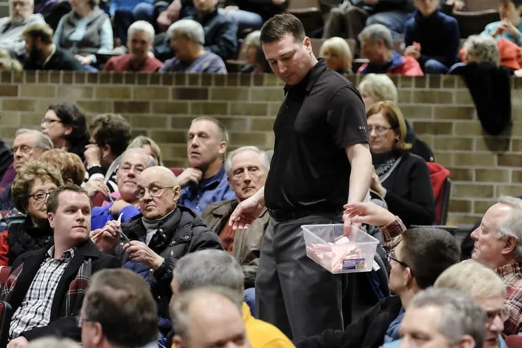Ben Uhl collects ballots during Woodbury County Republican Precinct 28 caucus at East High School in Sioux City, Iowa, on Feb. 1, 2016. Democratic leaders approved 99 satellite caucuses for 2020 to increase participation, including one in Philadelphia.