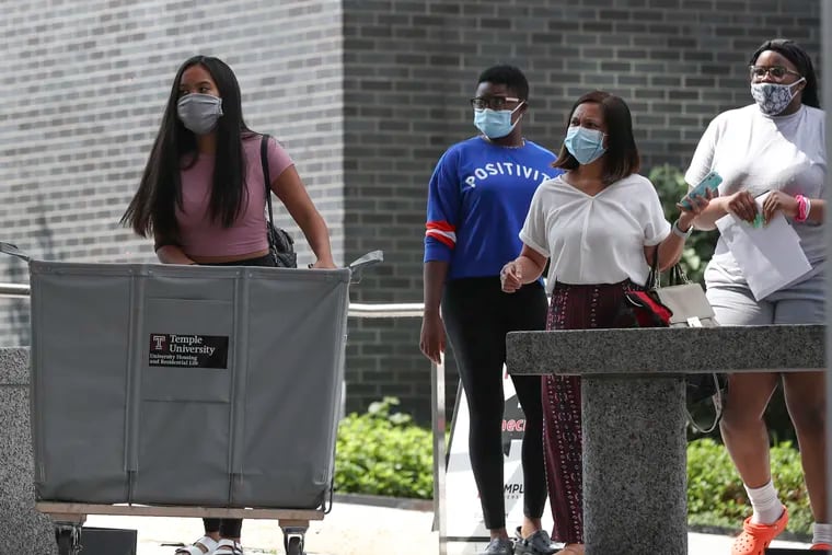 Students move into Morgan Hall at Temple University in Philadelphia on Wednesday, the same day the school announced two student cases of the coronavirus.