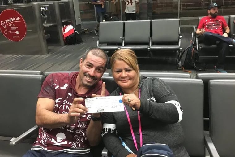 Jorge Rodriguez and Maritza Cordero Figueroa hold up a boarding pass  before flying to San Juan, Puerto Rico., to check up on family members in Hurricane Maria’s wake.