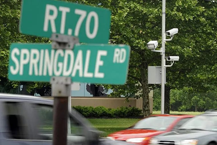 Red-light cameras (right) are mounted on eastbound Route 70, at Springdale Road in Cherry Hill. (Tom Gralish/File photo)