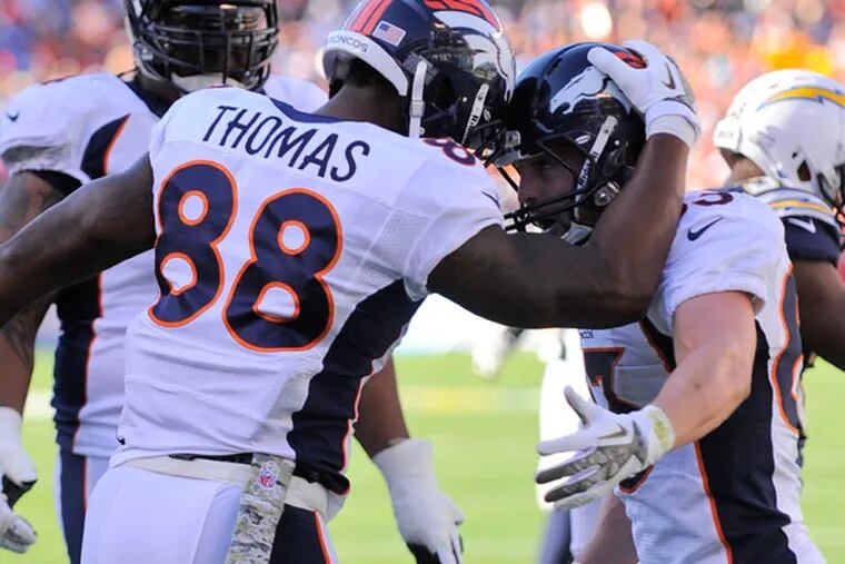 Broncos wide receiver Demaryius Thomas (88) celebrates with teammate Wes Welker after his second touchdown reception against the San Diego Chargers in a NFL football game Sunday, Nov. 10, 2013, in San Diego. (Denis Poroy/AP)
