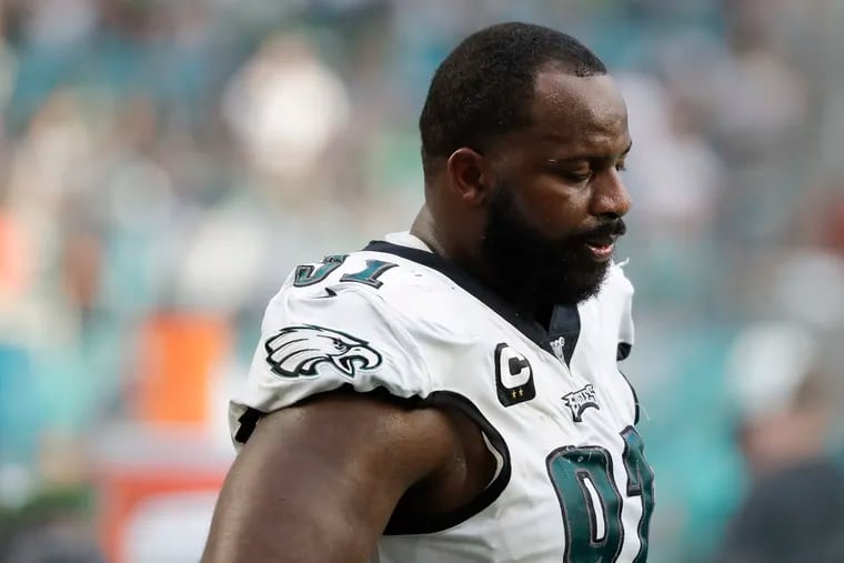 Eagles defensive tackle Fletcher Cox looks down while on the sidelines late in the fourth quarter of Sunday's loss to the Miami Dolphins.