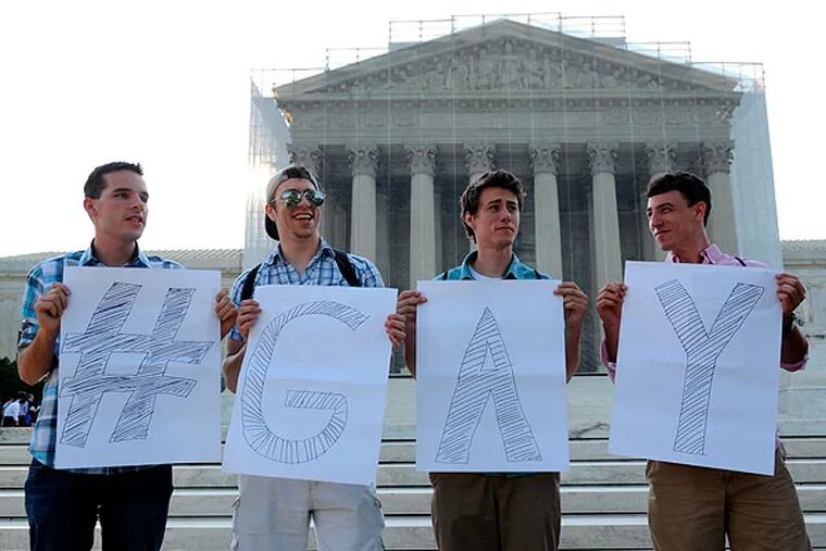 Casey Oakes, 26, of Monroe, N.J., left, Dan Choyce, 21, of Sicklerville, N.J., center left, Zach Wulderk, 19, of Hammonton, N.J., and his brother Dylan Wulderk, 22, right, wait for a ruling on same sex marriage at the Supreme Court in Washington, Wednesday, June 26, 2013. (AP Photo/Cliff Owen)