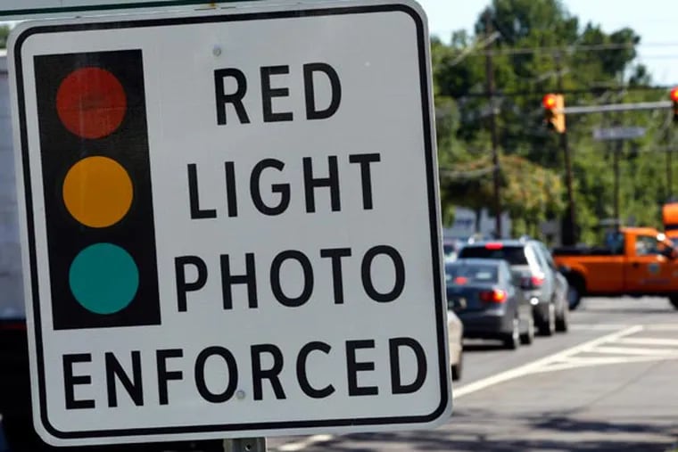 Those controversial red-light cameras, already in use in Philadelphia, New Jersey and elsewhere in the country, could soon make their first appearances in the Philadelphia suburbs. (AP Photo/Mel Evans)