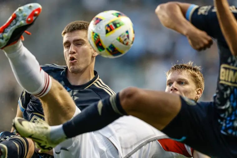 Union forward Mikael Uhre and Toronto defender Sigurd Rosted battle for the ball in a crowd during the first half.