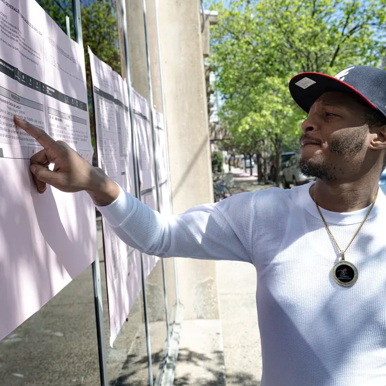 Jerome Upchurch reads voters information posted outside the Fleisher Art Memorial election polling place on Tuesday, Apr 23, 2024, in South Philadelphia, Pa. .