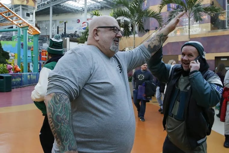 Chuck &quot;Tat Man&quot; Solomon  high-fives Sean Bolopue while they walk in the Nickelodeon Universe Amusement Park in the Mall of America on Friday, February 3, 2018 in Bloomington, Minn. Bolopue is from Deptford, New Jersey.